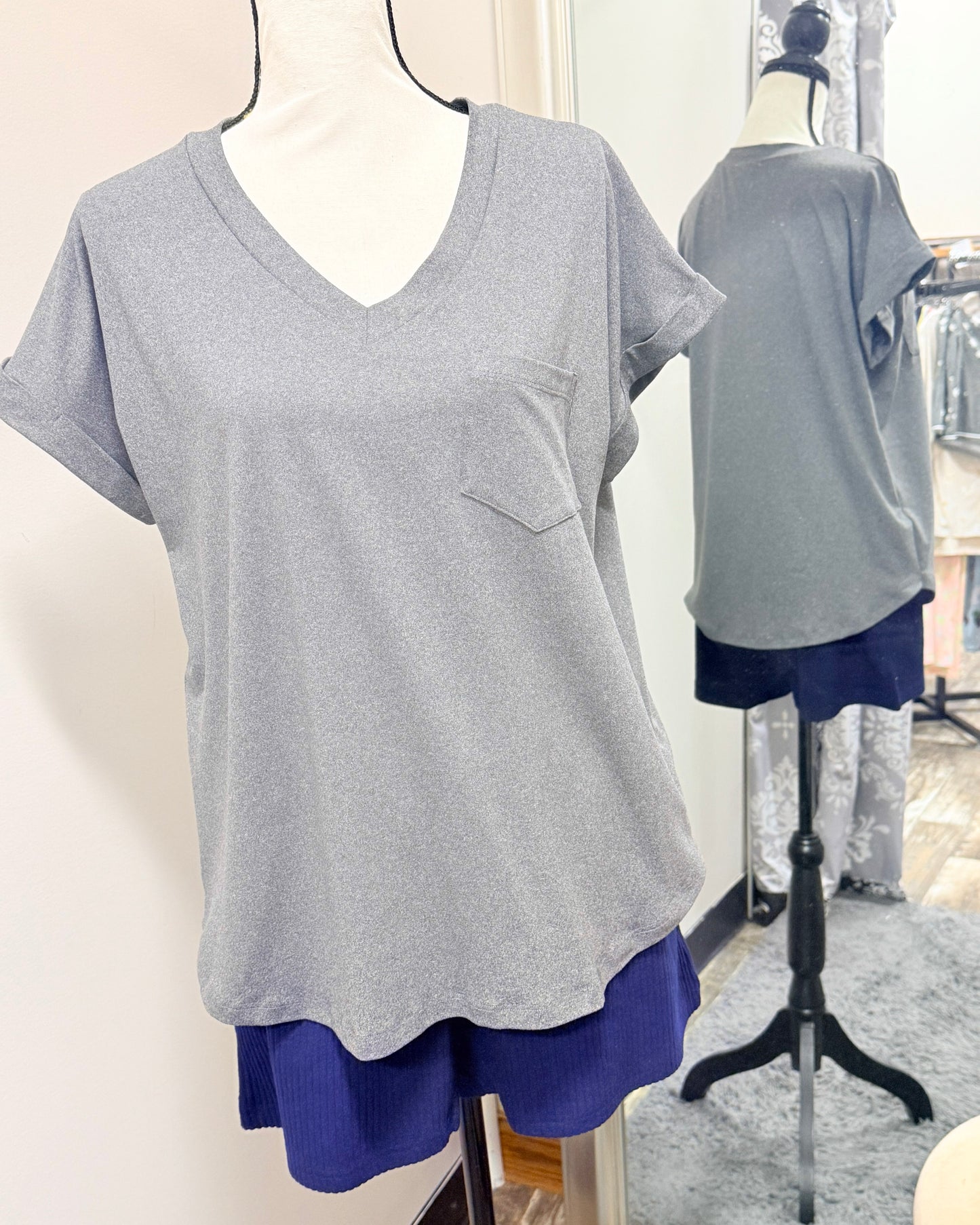 Gray t-shirt with a pocket on a mannequin against a neutral background