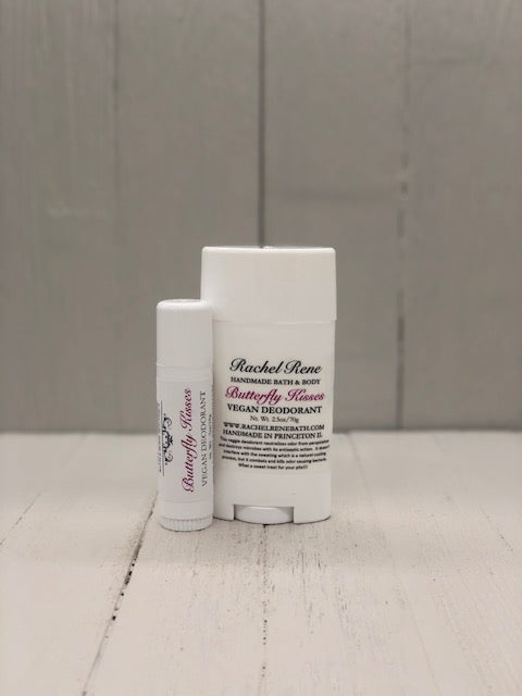 A white deodorant stick labeled "Butterfly Kisses" in pink letters.