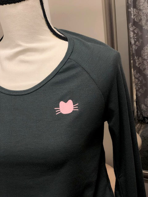 A dark gray long sleeve top with a small pink cat face on the upper right.
