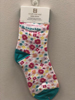 White crew socks with small pink, teal, orange, and yellow flowers. Text on the outside of the ankle reads "beautiful, capable, worthy"