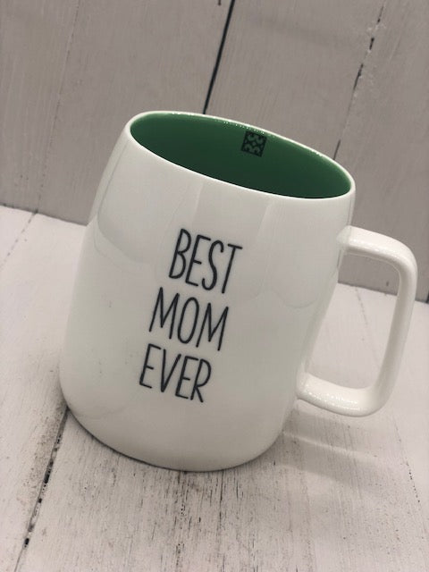 A white mug with the text "BEST MOM EVER". The inside of the mug is sage green.