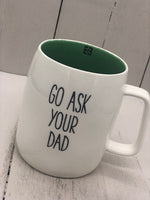 A white mug with text "GO ASK YOUR DAD". The inside is sage green.