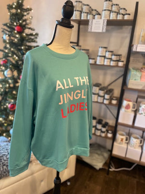 A side view of a light blue sweatshirt with text reading "ALL THE JINGLE LADIES".