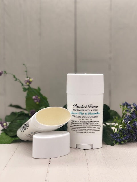 A white deodorant stick labeled "Green Tea & Cucumber" in teal letters.