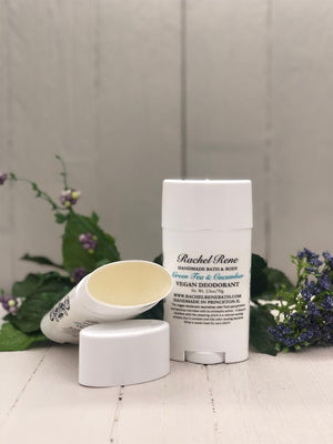 A white deodorant stick labeled "Green Tea & Cucumber" in teal letters.