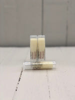 Pale yellow lip butter in a clear tube labeled "Banana Daiquiri"