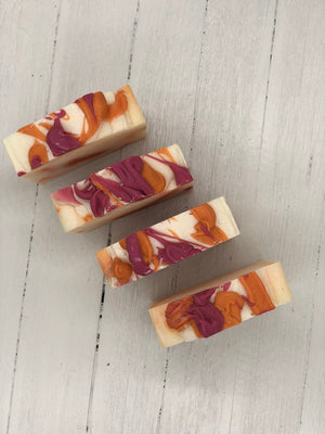 
            
                Load image into Gallery viewer, A white soap bar with pink and orange swirls.
            
        