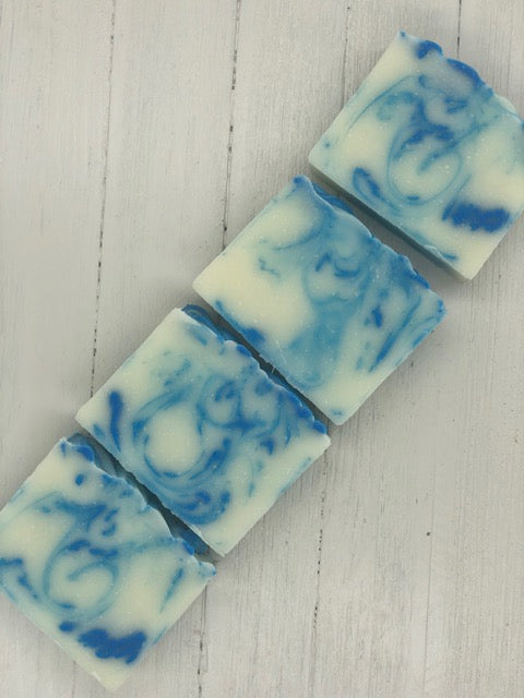 A white bar of soap with ocean blue swirls.